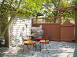 Patio seating outdoors with barbeque and propane